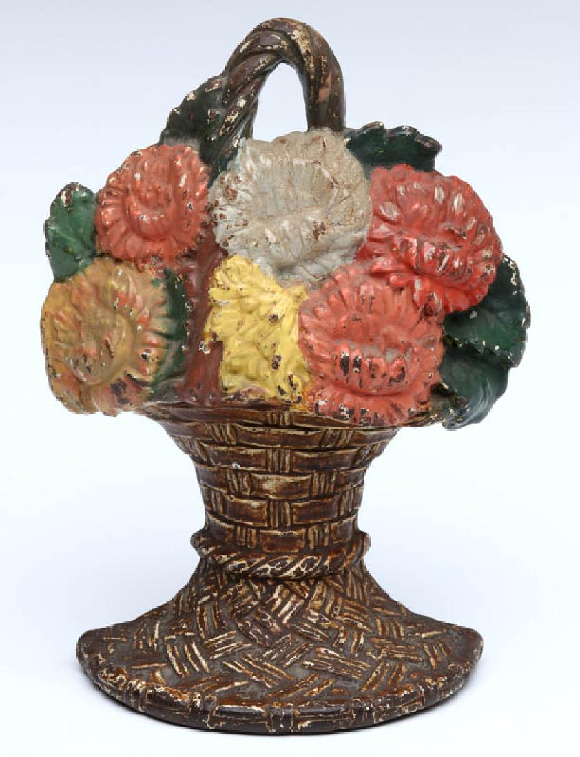 A WAVERLY STUDIOS FLOWER BASKET DOORSTOP C. 1926: A single-sided polychrome doorstop or bookend, patent dated 1926, signed on the back. Measures 6.25 x 4.5 x 2.25 inches. We happily provide seamless in-house packing and shipping services on nearly ev