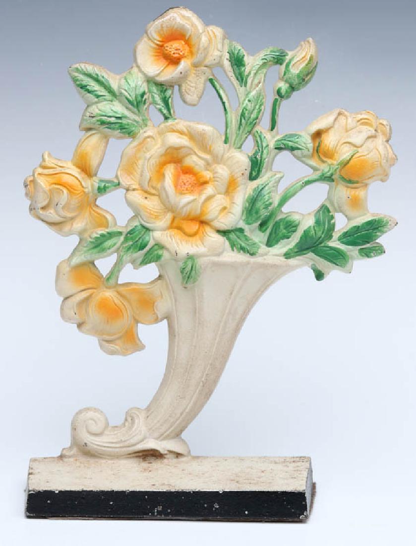 A HUBLEY ROSE VASE DOORSTOP NO. 441: A single-sided polychrome doorstop, Hubley Rose Vase #441, marked on the back. Measures 10 x 7.5 x 2.5 inches. We happily provide seamless in-house packing and shipping services on nearly everything w