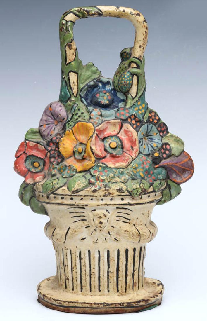 A CAST IRON FLOWER BASKET DOORSTOP: A single-sided polychrome doorstop, unsigned. Measures 11.5 x 7 x 2.25 inches. We happily provide seamless in-house packing and shipping services on nearly everything we sell.