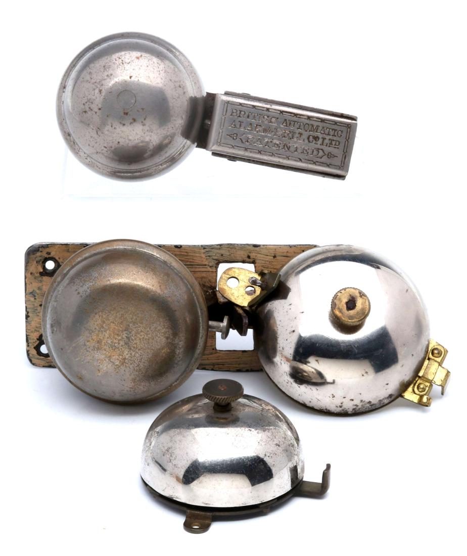 A COLLECTION SPRING DRIVE BURGLAR ALARMS C. 1890s: A British Automatic Alarm Co. slide under door alarm, plus three door or window alarms, two patent dated 1889. Largest measures 4.5 x 2 inches. We happily provide seamless in-house packing and shippin