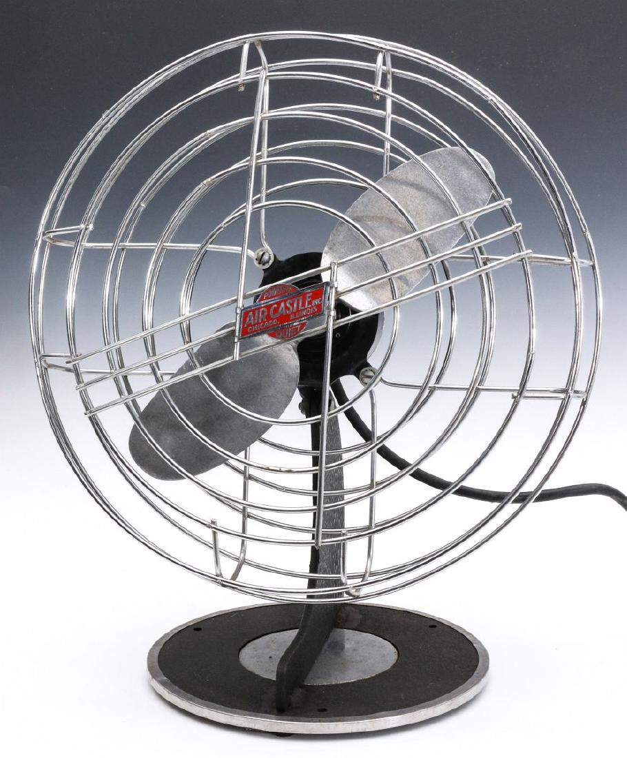 AN AIR-CASTLE ART DECO TABLE FAN CIRCA 1947: Signed with an Air-Castle badge on the guard, sheet metal base with a black wrinkle finish, chrome accents, bullet back, one piece cast aluminum blade in the form of an airplane prop, one-speed, signe