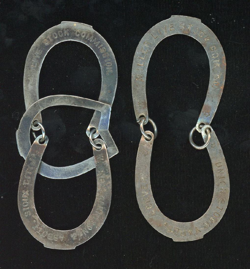 HORSESHOE FORM LIVESTOCK COMMISSION ADVTG PUZZLES: Stamped steel horseshoe form puzzles advertising Wagner, Garrison & Abbott Live Stock Commission, Sioux City, IA., and Miller Live Stock Com. Co., Union Stock Yards, Denver, lettered 'Let us know your