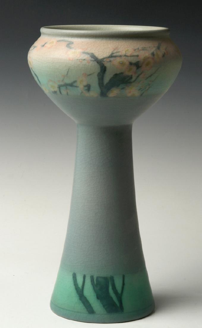 A 12-INCH ROOKWOOD VELLUM VASE SIGNED COYNE 1909: Sally E. Coyne (Early 20th C.) 1909 The unusual form decorated Japanesque with a frieze of cherry blossom prunus on shaded pink and blue ground encircling the upper portion, interrupted by plain blue 