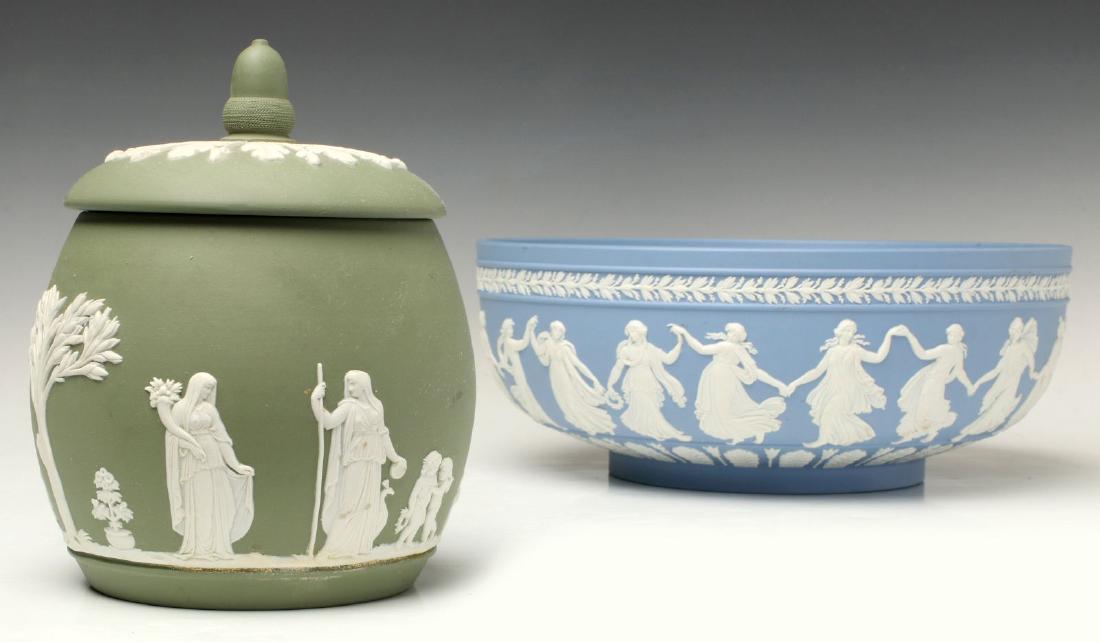 A GREEN JASPERWARE JAR AND LIGHT BLUE BOWL: A green Jasperware covered jar and a larger light blue bowl, bases incised 'Wedgwood' and 'Made in England,' bowl with additional clear 'AW' mark. Jar measures 6.5 x 5 inches, bowl measures 4 x 10.25