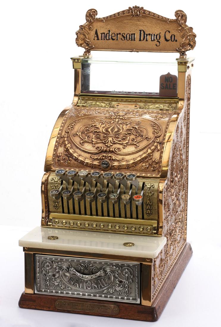 A NICE NATIONAL CASH REGISTER MODEL 313 W/TOP SIGN: A fine little polished model in working condition, the top sign with dolphins either side of blacked lettering of Anderson Drug Co. over the ornate polished brass case, marble front ledge, nickel-plat