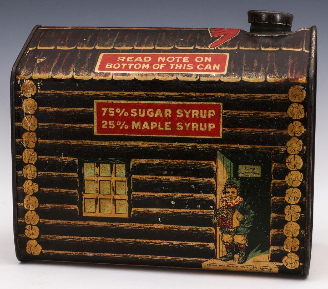 A GOOD EARLY LARGE SIZE LOG CABIN SYRUP CONTAINER: The 5 pound tin with bold graphics, including a child in the doorway, 'FROM MY CABIN TO YOUR TABLE' and a HOME SWEET HOME sign on the cabin wall. Measures 6.25 x 4 x 7 inches. We happily provide seaml