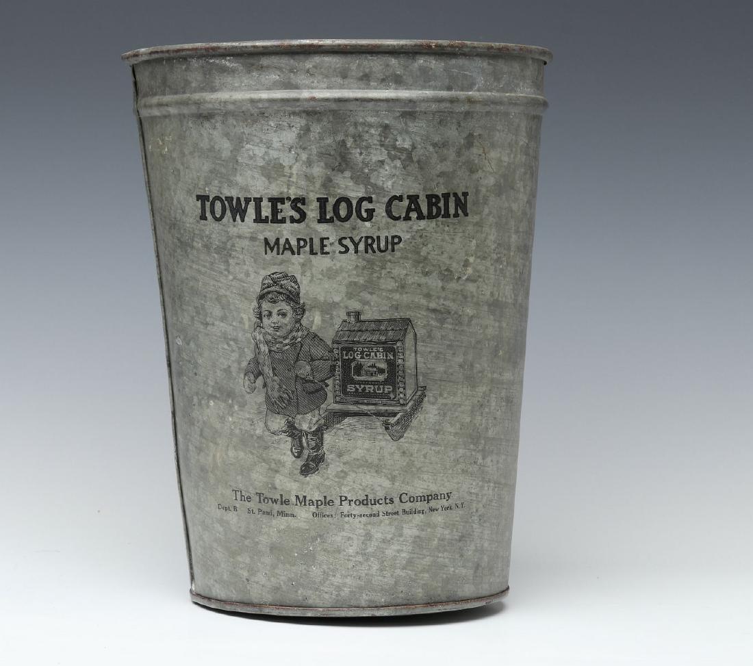 ADVERTISING SAP BUCKET FOR TOWLE'S LOG CABIN SYRUP: The inverted cone-shape galvanized bucket with hanging hole and black transfer of a Victorian child towing a large TOWLE'S LOG CABIN SYRUP tin on a sled with wood runners, lettered The Towle Maple Pro