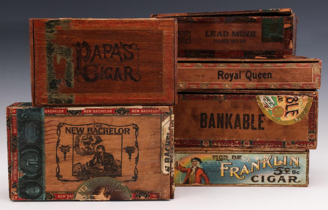 A COLLECTION OF SIX GOOD MAHOGANY CIGAR BOXES: Each with colorful graphics of interesting subject matter. Measure 2.25 x 8 x 4.75 inches up to 3.25 x 9.75 x 5.5 inches. We happily provide seamless in-house packing and shipping services on nearly e