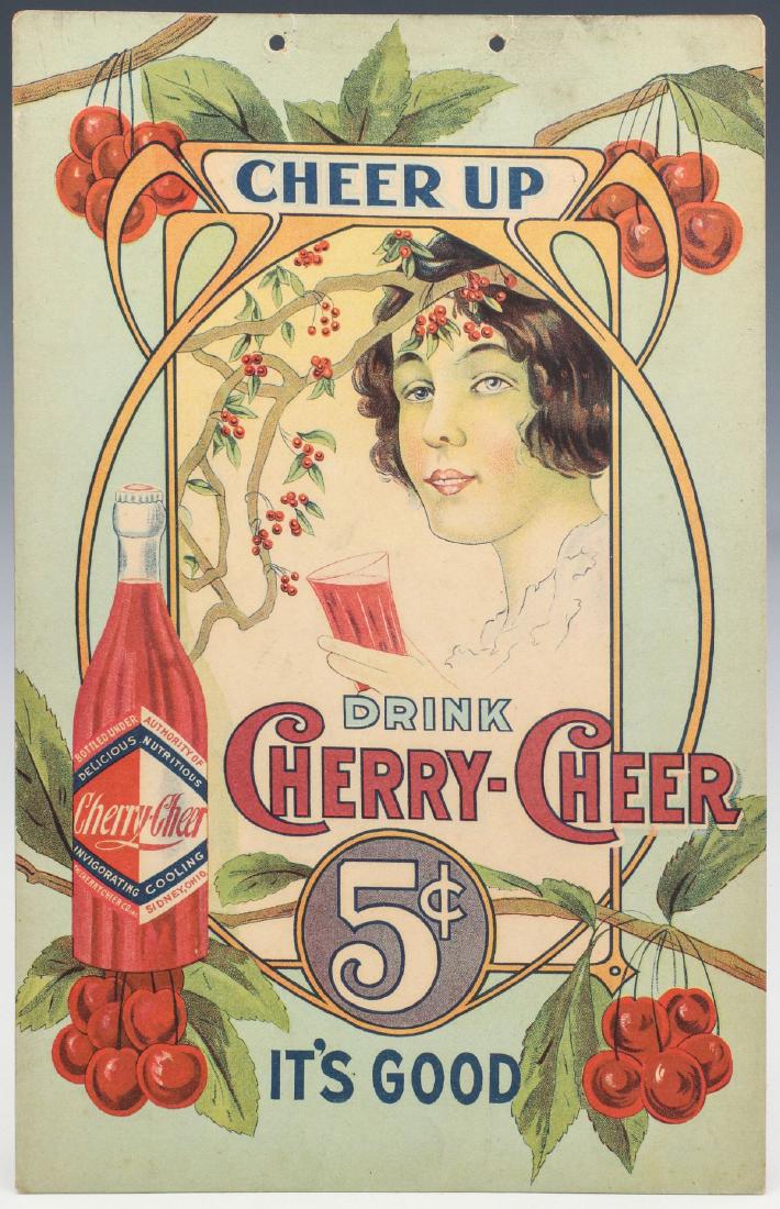 A 1920s CHERRY-CHEER 5¢ SODA POP ADVERTISING SIGN: The polychrome cardboard sign for 'Cherry-Cheer' soda pop for21 The Cherry Cheer Co. of Sydney, Ohio, nicely illustrated Art Nouveau graphics, reads 'Drink Cherry-Cheer 5-cents It's Good.' Measures 11