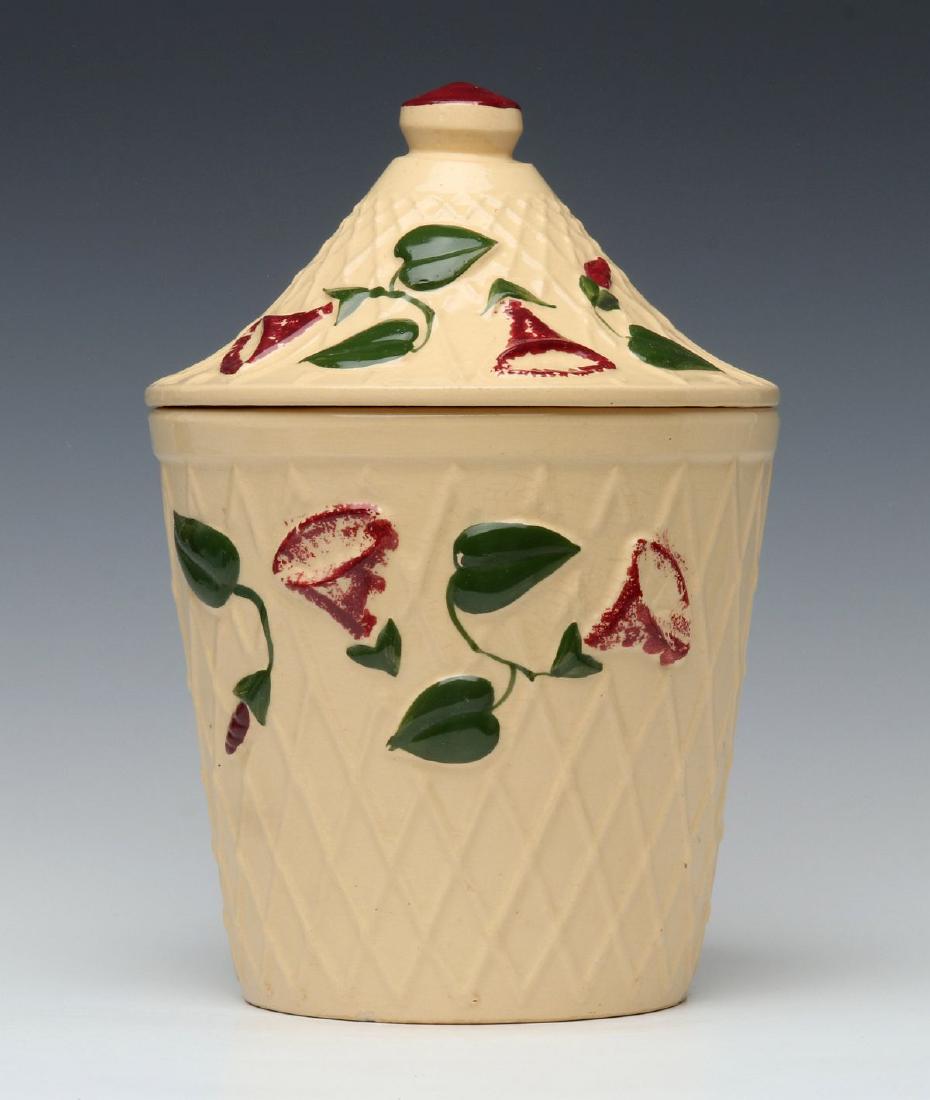 A RARE WATT POTTERY 'MORNING GLORY' COOKIE JAR: A cookie jar with lid in the Morning Glory pattern, impressed Oven Ware mark on the base, shape number 95. Measures 10.5 x 7.25 inches. We happily provide seamless in-house packing and shipping servic