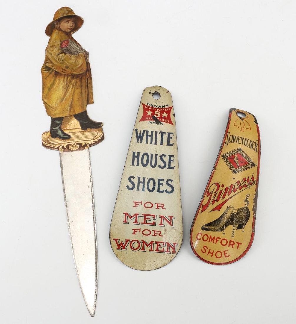 THREE EARLY 20TH CENTURY ADVERTISING LITHO ITEMS: Two shoe horns: White House Shoes for MEN for WOMEN; and SCHOENECKER PRINCESS COMFORT SHOE; and a Uneeda Biscuit letter opener. Measure 8 inches and 4.5 inches. We happily provide seamless in-house pa