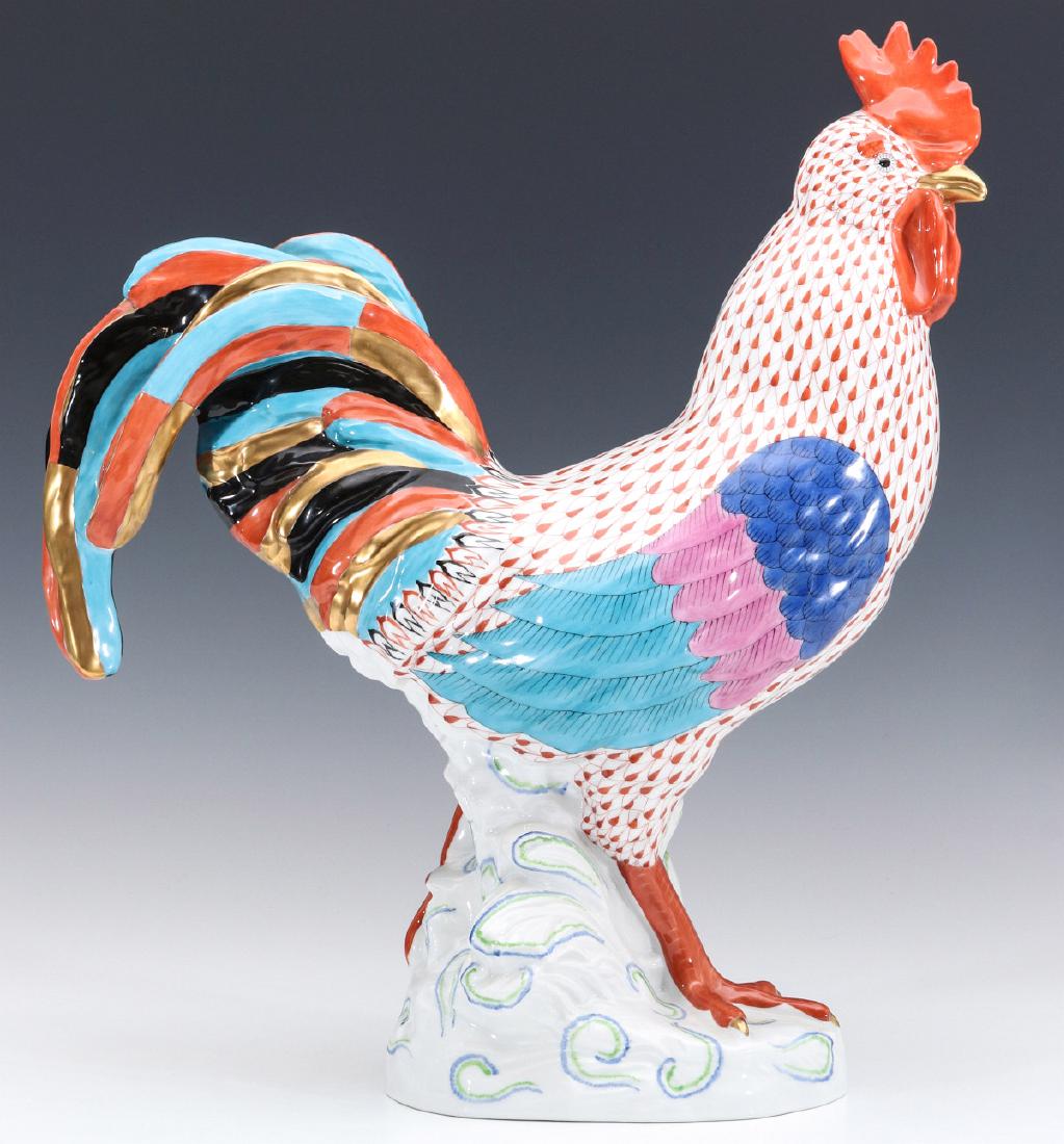 A LARGE HEREND RUSTRED FISH NET DECORATED COCKEREL: The hand painted decoration of rust red feathering, gold beak, turquoise, blue, and pink decoration wings; black gold, turquoise and rust tail feathers. Measures 16 x 14 x 5 inches. We happily provide