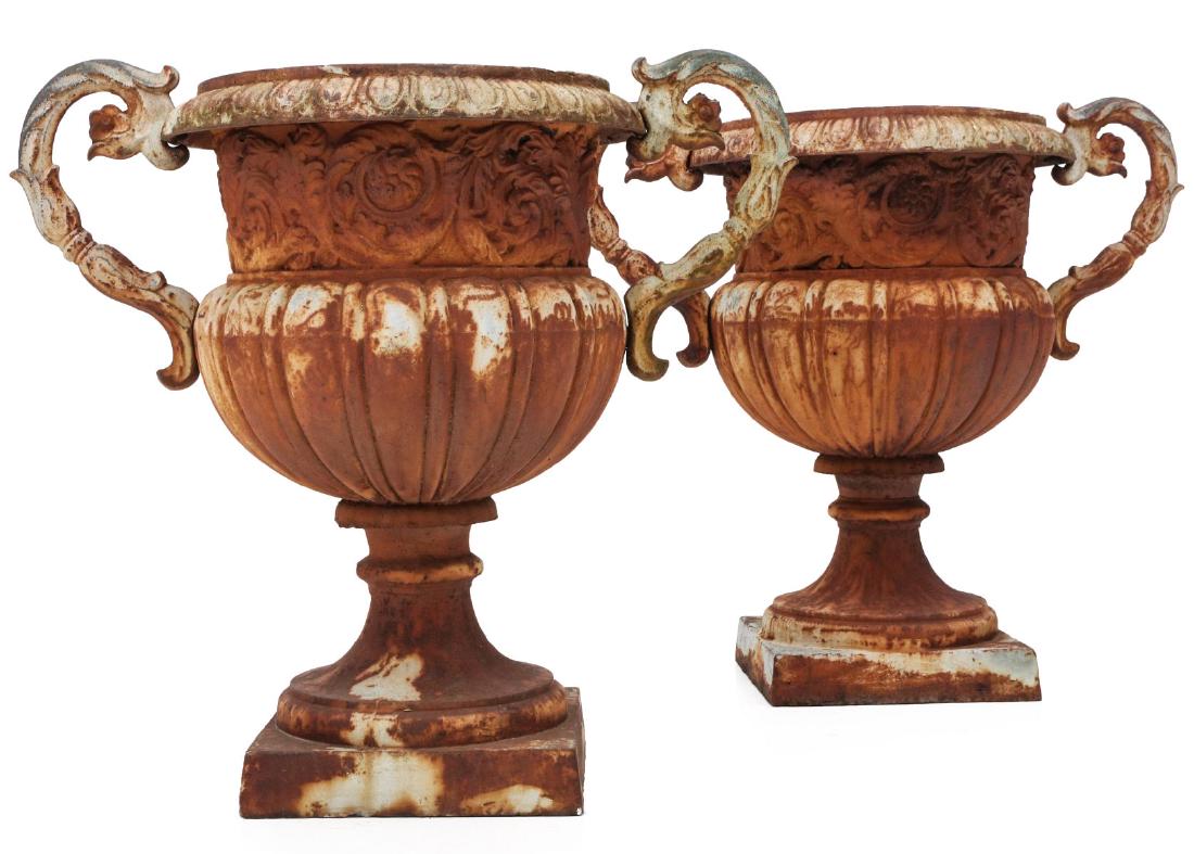 A PAIR MONUMENTAL CAST IRON GARDEN URNS: Each cast iron campagna form urn with egg-and-dart rolled rim, ornate scroll handles, wide band of rococo swirl casting, swollen ribbed bidy, socle base and square plinth foot. Measures 3 x 35 x 21.5 
