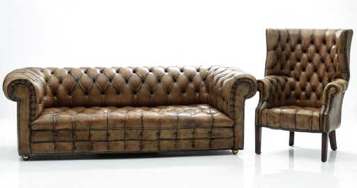 A Vintage Leather Chesterfield Sofa And Wing Back