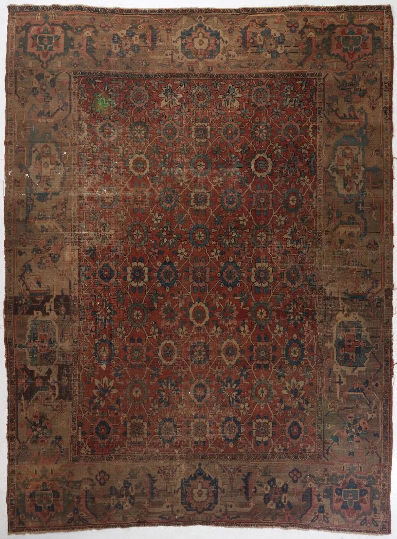 AN ANTIQUE PERSIAN HERIZ AREA RUG: The floral lattice field surrounded by a wide border with bold palmette-like designs. Measures 154 x 119.5 inches. We happily provide seamless in-house packing and shipping services on nearly everythi