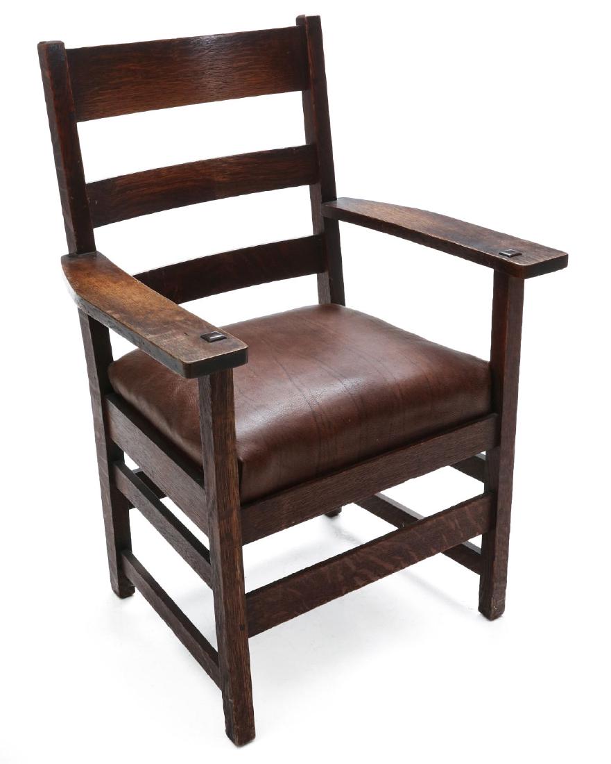 A L. & J.G. STICKLEY MISSION STYLE OAK ARM CHAIR: The back with three horizontal slats, flat arms, red clamp decal mark, original finish. Measures 36.5 x 25.75 x 21 inches. We happily provide seamless in-house packing and shipping services on nearly 