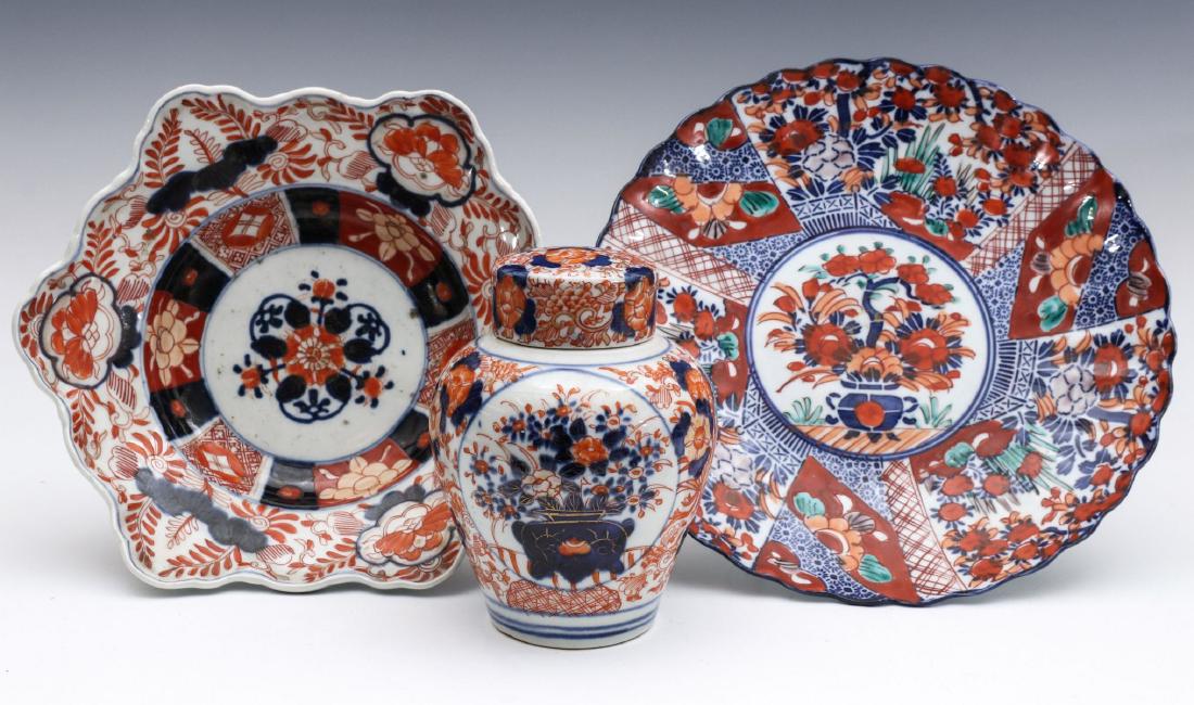 NINETEENTH CENTURY IMARI PORCELAIN CHARGERS AND JAR: An Imari lobed edge basin, a larger fluted edge charger, plus a covered ginger jar form vessel. Sizes range from 2.75 x 9 to 5.75 x 4 inches. We happily provide seamless in-house packing and shipping