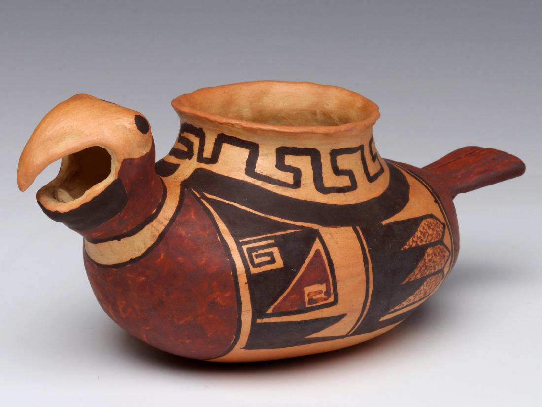 MICHAEL HAWLEY CHAKOPTEWA (1948 - 2012) HOPI: The figural parrot vessel with traditional designs in red and brown on buff ground, signed on the under side. Measures 4 x 9 x 4.5 inches. We happily provide seamless in-house packing and shipping ser