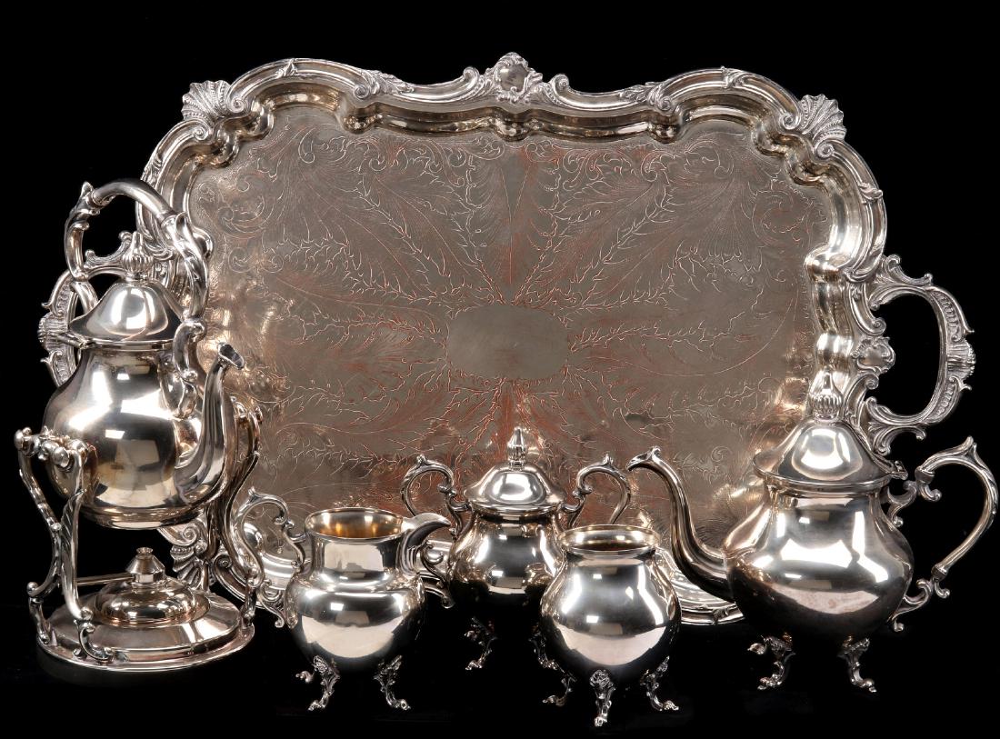 ORNATE ROCOCO MOTIF SILVER PLATE TEA & COFFEE SET: The six-piece solver on copper set as shown. Tray measures 28.75 x 17.75 inches, large tipper 15.25 x 9 x 7.25 inches, smallest four legged pot measures 5.25 x 3.75 inches. We happily provide seamless