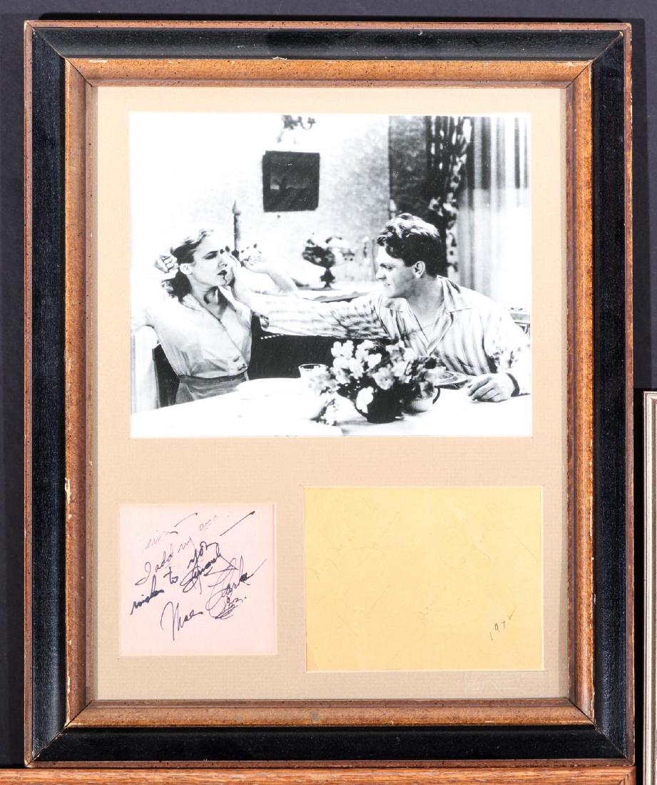 JAMES CAGNEY AND MAE CLARK AUTOGRAPHS AND PHOTO: The clipped signatures of James Cagney and Mae Clark matted and framed with an image of the two Hollywood actors in a scene known as 'The Grapefruit Scene' from the 1931 movie The Public Enemy. Frame 