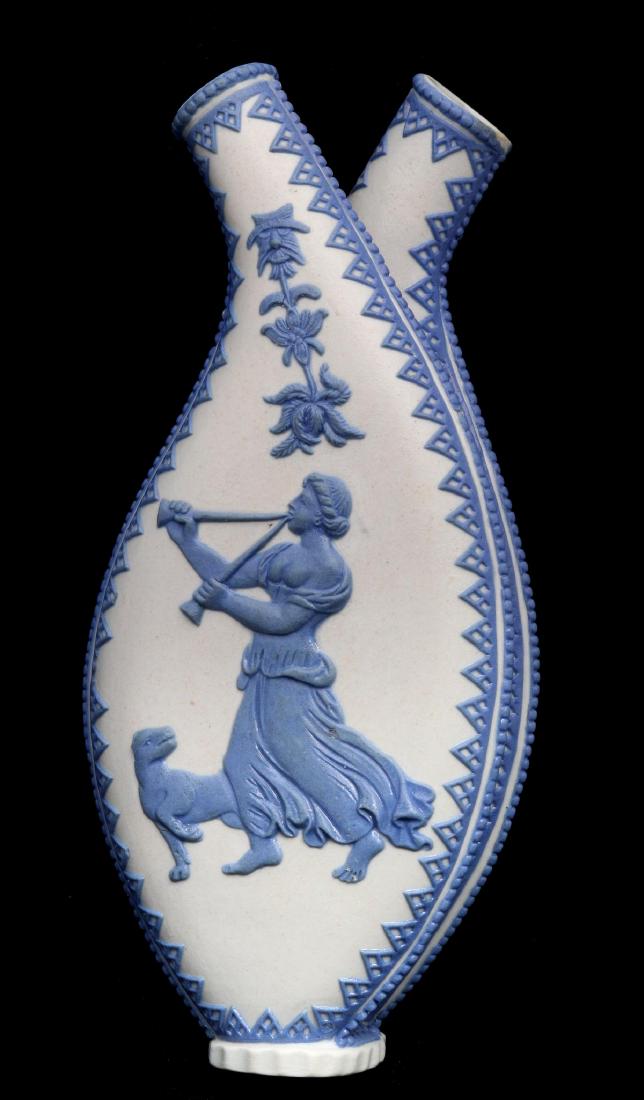 ANTIQUE JASPERWARE DOUBLE FLASK AND PITCHERS: A double flask, white body of two separate vessels fused to one another and each sprigged with honeycomb scallops and a classical woman with canine in relief, unsigned. Plus three pitchers with sprigg