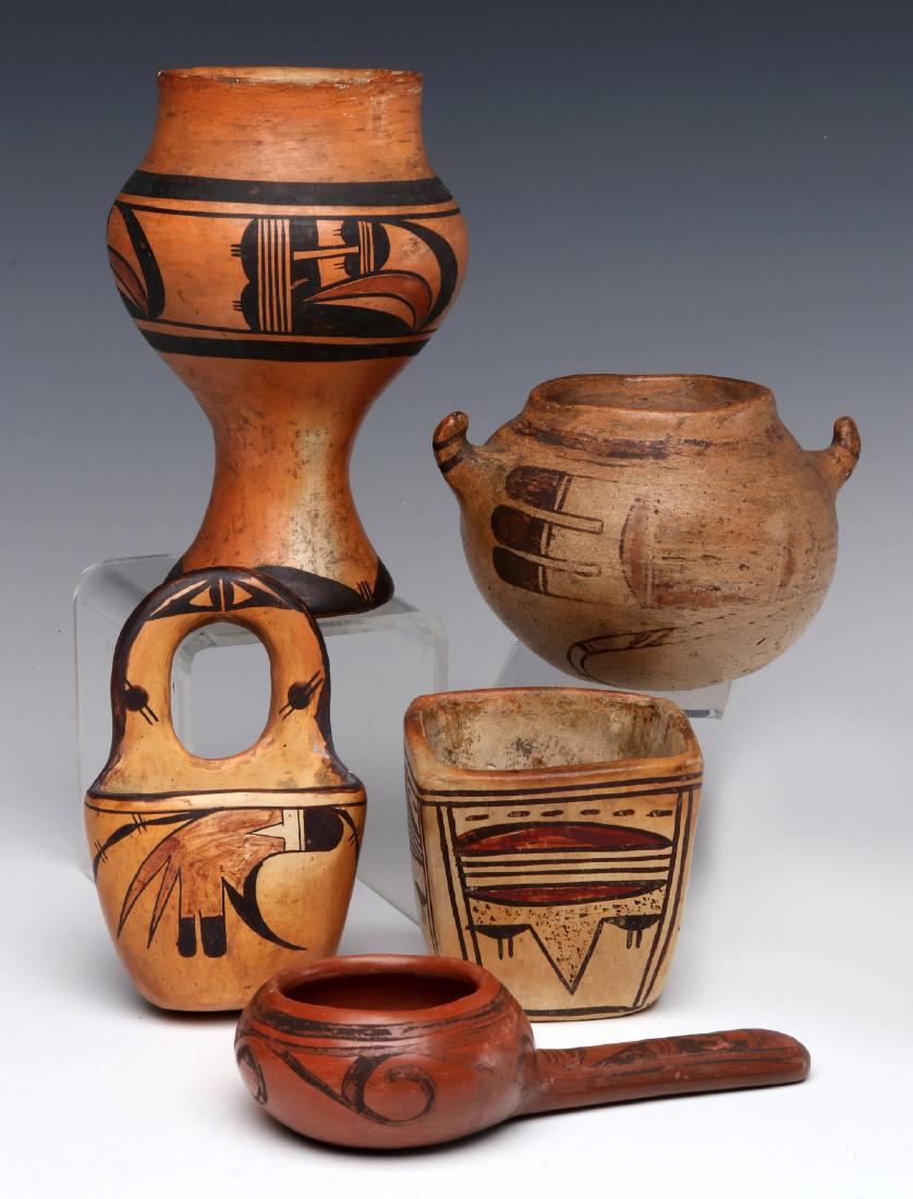 A COLLECTION OF FIVE HOPI INDIAN POTTERY OBJECTS: A tall goblet, ball shape olla with handles, a hanging basket, a square vase and ladle or bowl with side handle. Measurements range from 5 x 3.25 x 1.75 inches to 6.25 x 3.75 inches. We happily provid