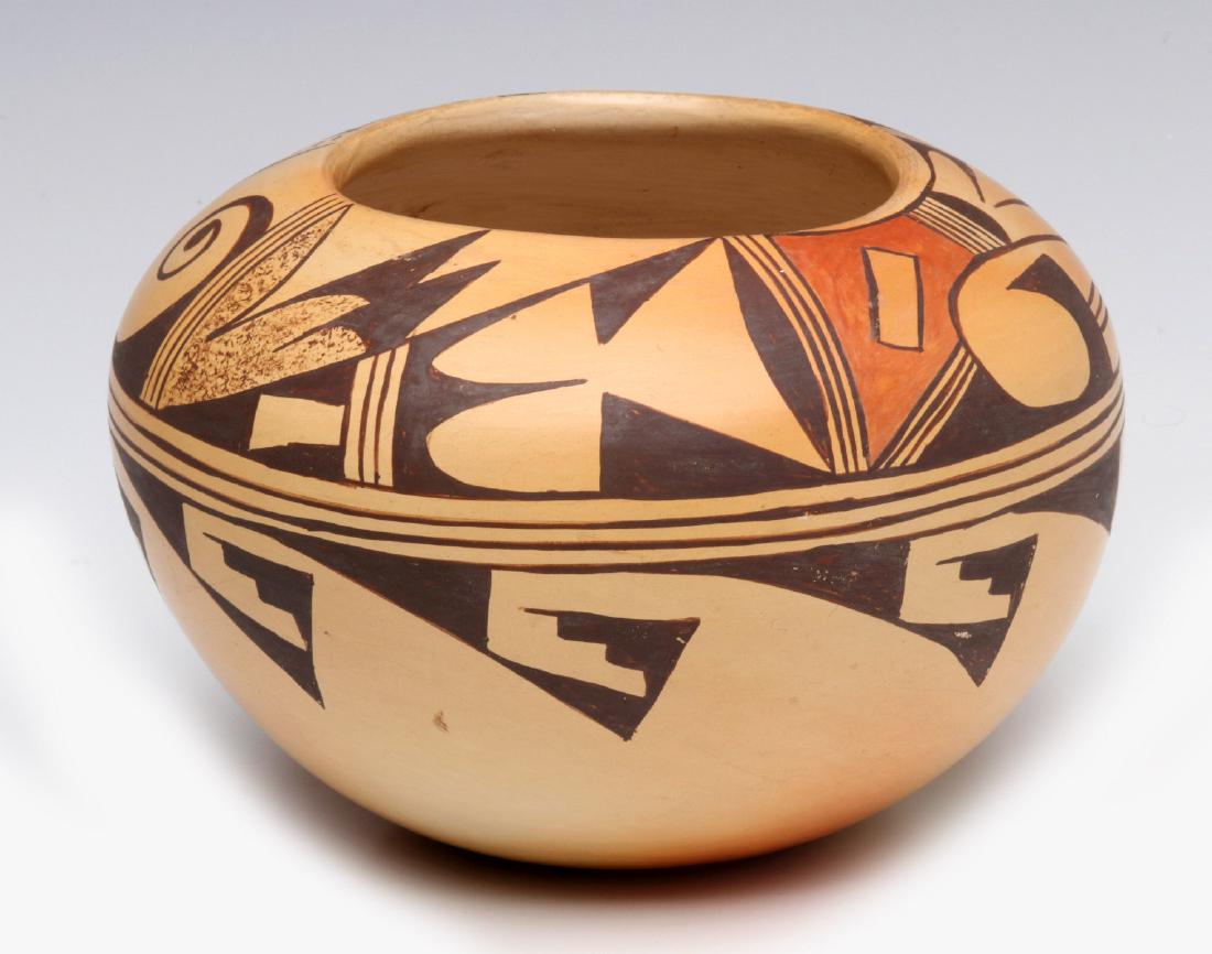 A NICE PATTY MAHO HOPI-TEWA POTTERY JAR: A nice example of design form and the random subtle effects of firing, traditional designs of scrolls, feathers and geometrics in brown and orange of buff ground, signed underside of the base. Measure