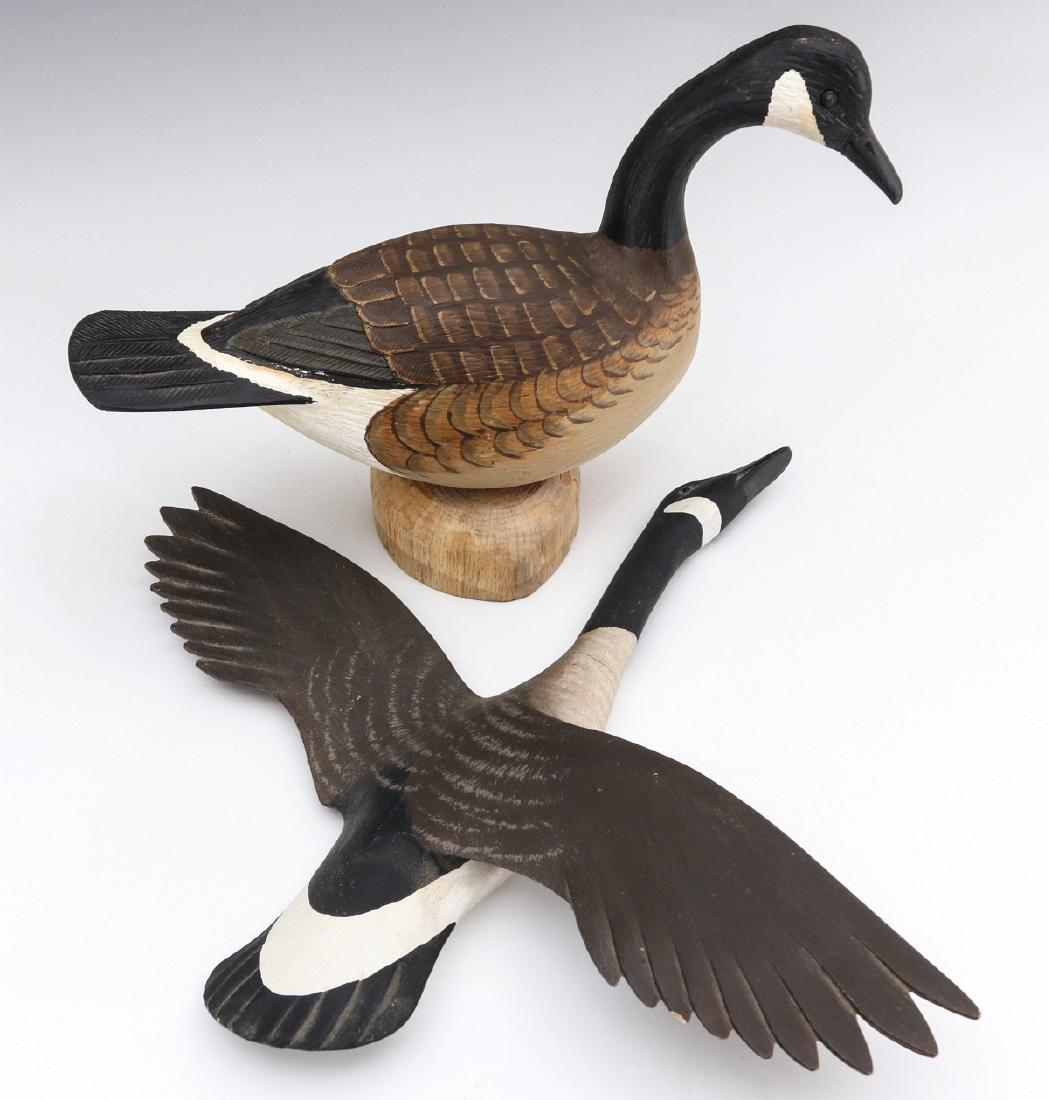 STAVELY AND REINERI CANADIAN GEESE WOOD CARVINGS: Two hand-carved and painted Canadian goose figures: the hanging goose carving by Dave Stavely (Easton, Maryland) signed under one wing; A carving by Lou Reineri (born 1922) signed on the base and date