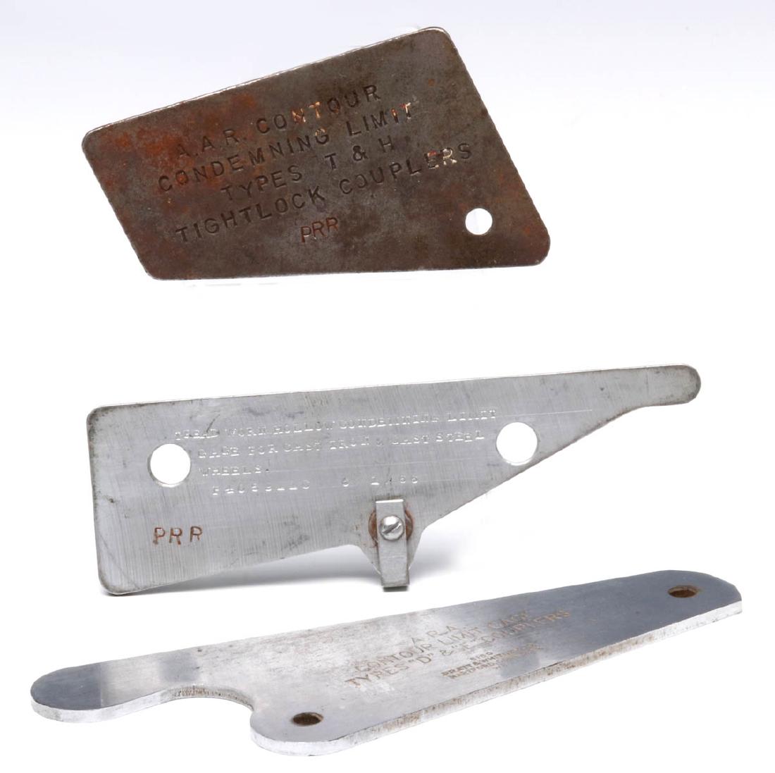 PENNSYLVANIA RAILROAD RAIL CAR WHEEL GAGES: A PRR marked A.A.R. Contour Condemning Limit types T & H tightlock couplers; a Treadworn Hollow Condenmning Light Gage for Cast Iron & Cast Steel Wheels, dated 1966; and an A.R.A. Contour Limit Gage t