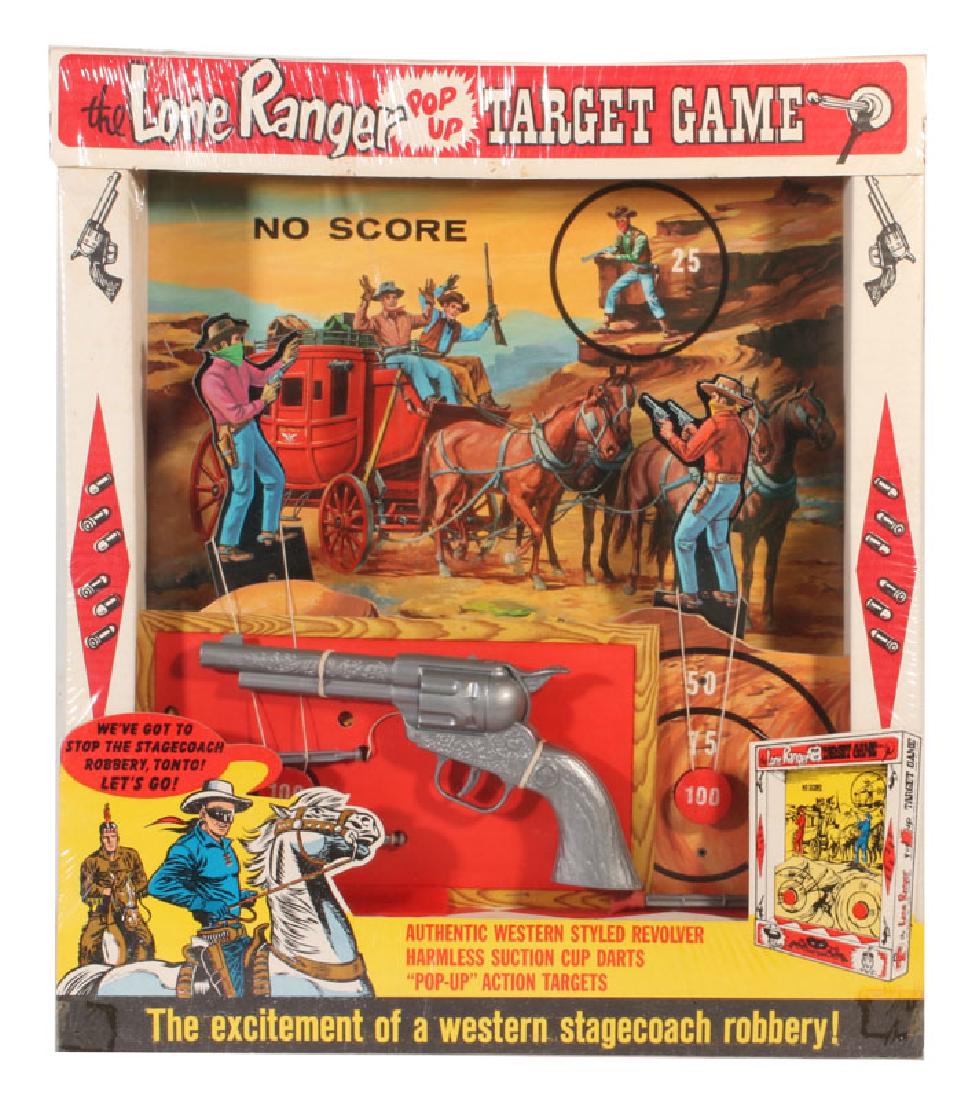 LONE RANGER STAGECOACH ROBBERY POP UP TARGET GAME: 1966 Wrather Corporation game in original box and unopened cellophane; with a 10 inch long plastic spring-loaded dart shooting revolver, three 3.5 inch plastic darts with safety tips, stagecoach hold-