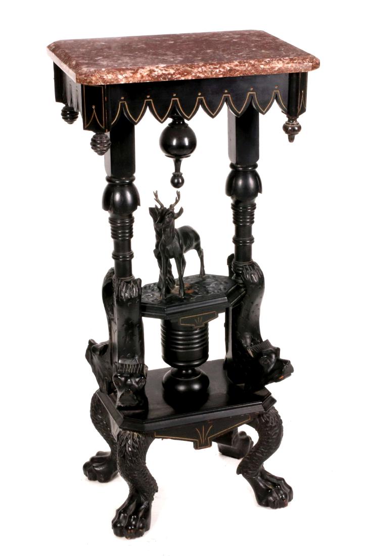 AN UNUSUAL VICTORIAN RENAISSANCE REVIVAL STAND: The rouge marble on conforming wood frame with inverted Gothic arches and drop finials, pair of turned supports with dolphin corbels centering a central pedestal shelf with figural deer, lower platfor