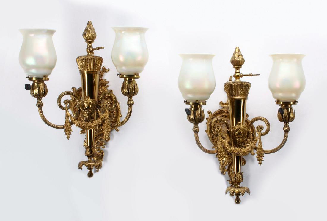 A PAIR 20TH C LOUIS XVI SCONCES WITH QUEZAL SHADES: Each of the cast brass sconce pair with central figural quiver topped by a flame finial, rococo cartouche back plate, scrolling arms with garland festoon, vertical sockets in palmette cups, two pearle