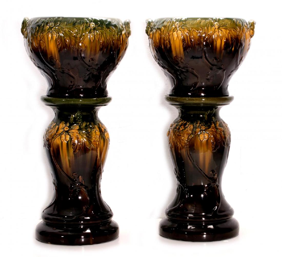CIRCA 1900 ART POTTERY JARDINIERE & PEDESTAL PAIR: The pair molded with oak leaf and acorn pattern, high gloss green, gold and brown variegated glazes, three digit markings similar to those found on Brush McCoy pottery examples. Each jardinere measure