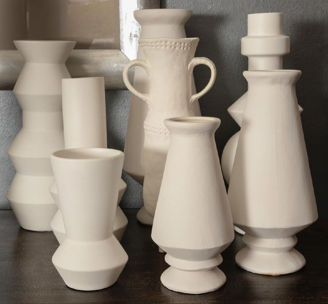 A COLLECTION OF EIGHT UNGLAZED BOTTLES AND VASES: Mostly modern shapes and designs up to 17 inches high. Sizes range form 8 x 4.25 up to 17 x 7 inches. We happily provide seamless in-house packing and shipping services on nearly everything we sell.