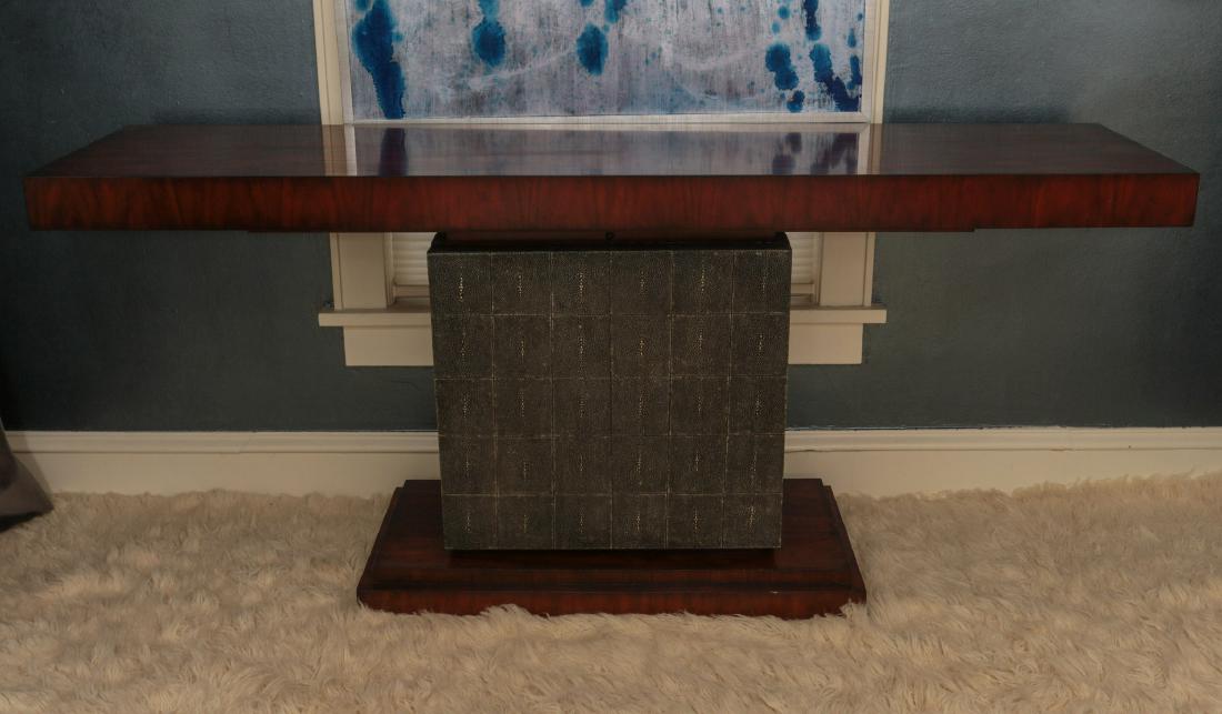 A RICH ROSEWOOD GRAIN AND FAUX SHAGREEN CONSOLE: Theodore Alexander. The slab top with outset front, central cabinet with storage and faux shagreen veneer, matching rosewood grain plinth base. Measures 33 x 18 x 76 inches. We happily provide seamles