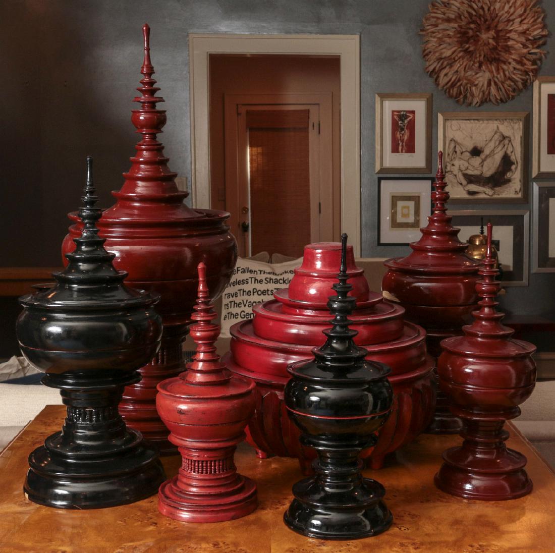 A COLLECTION OF BURMESE BUDDHIST OFFERING JARS: A collection of red and black Hsun-Ok offering vessels, pagoda and other forms in red and black. Sizes range from 12.5 x 4.75 up to 25 x 10 inches. We happily provide seamless in-house packing and shi