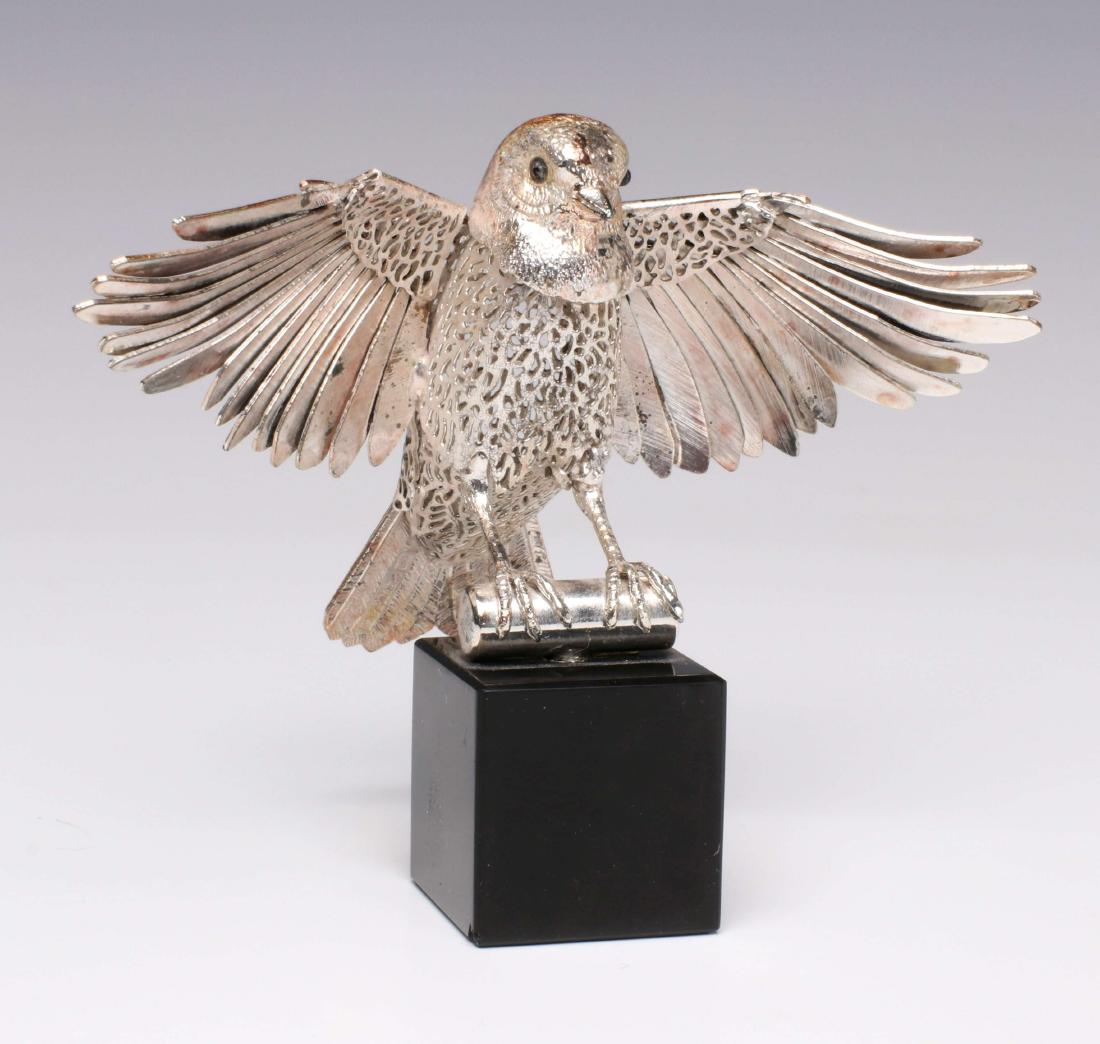 A CHRISTOFLE SILVER FIGURE OF A NUTHATCH BIRD: The silver plated pierced metal figure with detailed wing feathers on black glass base, from the lumiere d'argent collection. Measures 3.5 x 4.5 inches. We happily provide seamless in-house packing an