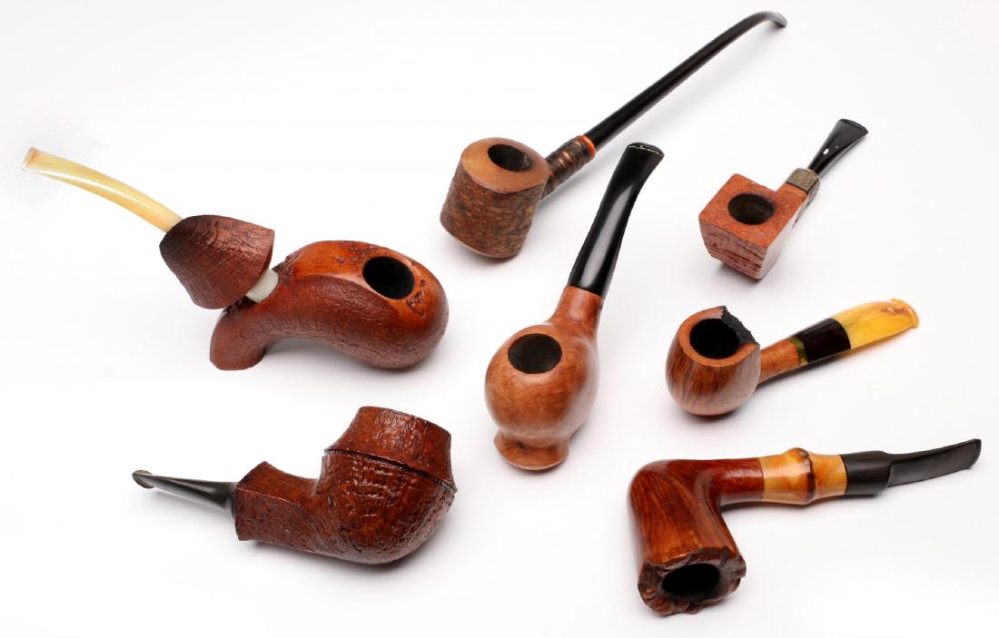 A COLLECTION OF ARTISAN-CARVED SMOKING PIPES: Signed examples include: J & J; 'Little Chub' French pipe with a long stem; Kurt Huhn; Castello 'Old Antiquari' pipe with a sterling band dated 1995; Savinelli 'Autograph'; a pipe signed with a W and 