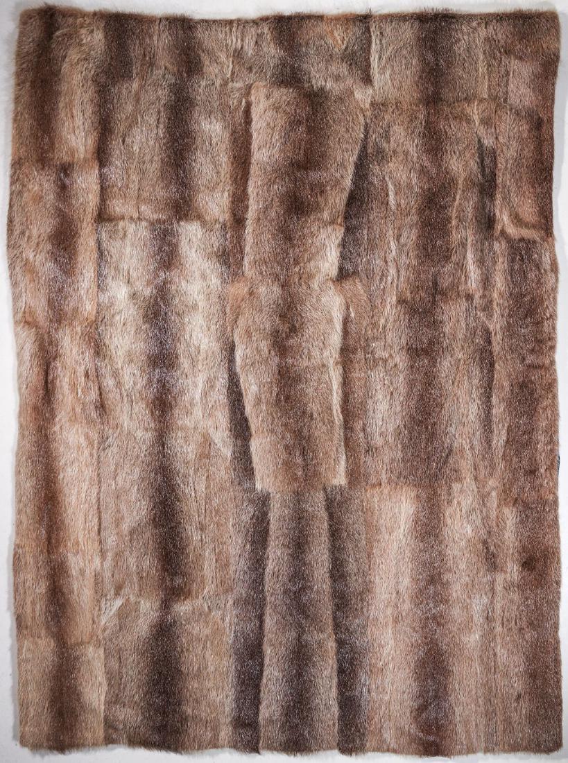 A QUEEN-SIZE SATIN LINED NUTRIA FUR THROW: The queen-size fur blanket of joined coypu pelts, lined in satin. Measures 83 x 68 inches. We happily provide seamless in-house packing and shipping services on nearly everything we sell.