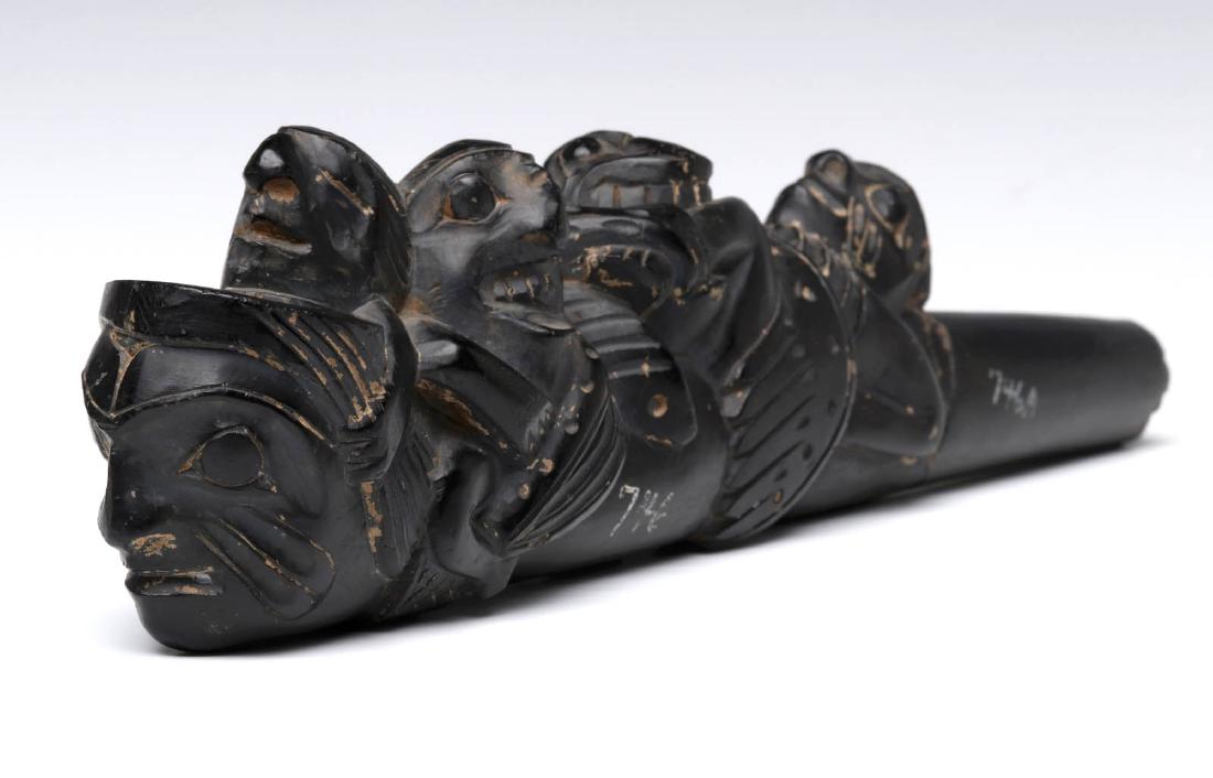 A LATE 19TH C HAIDA NORTHWEST COAST ARGILLITE PIPE: A smoking pipe carved from argillite by the Haida indigenous nation of the Northwest Coast of North America, the depiction of multiple mythical figures and masks, argillite is a slate-like material qu