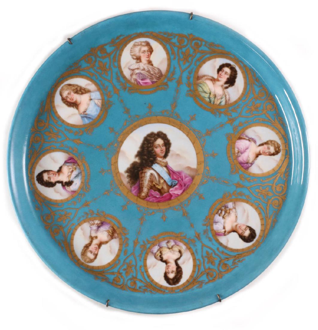 A LARGE SEVRES PORCELAIN CHARGER WITH PORTRAITS: The portrait of Louis, Dauphin of France, son of Louis XV on blue ground with gilt frame, the portraits of ladies of the court identified on the gold banner below each image and in black lettering ver