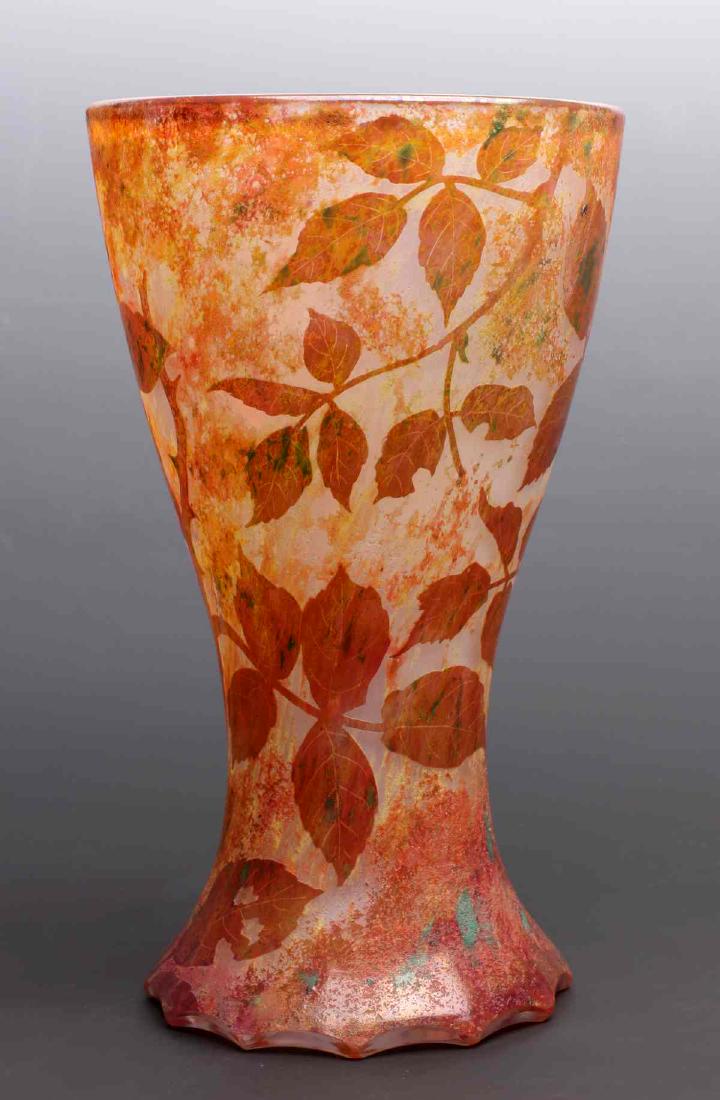 A FRENCH CAMEO GLASS VASE SIGNED DAUM NANCY C 1915: Circa 1915. The clambroth-colored glass vase overlaid with orange, burnt orange and rust enameled glass with scattered flecks of green, etched autumn leaf decoration carved in cameo relief, cut and po