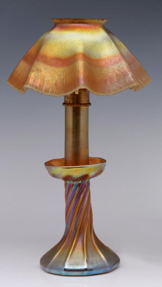 A LOUIS COMFORT TIFFANY GOLD FAVRILE CANDLE LAMP: The standard of twisted form with high ribs, flared base and upturned top with opening for a cylindrical gold favrile art glass stem, original brass fittings secure the stem and support the ruffled sh
