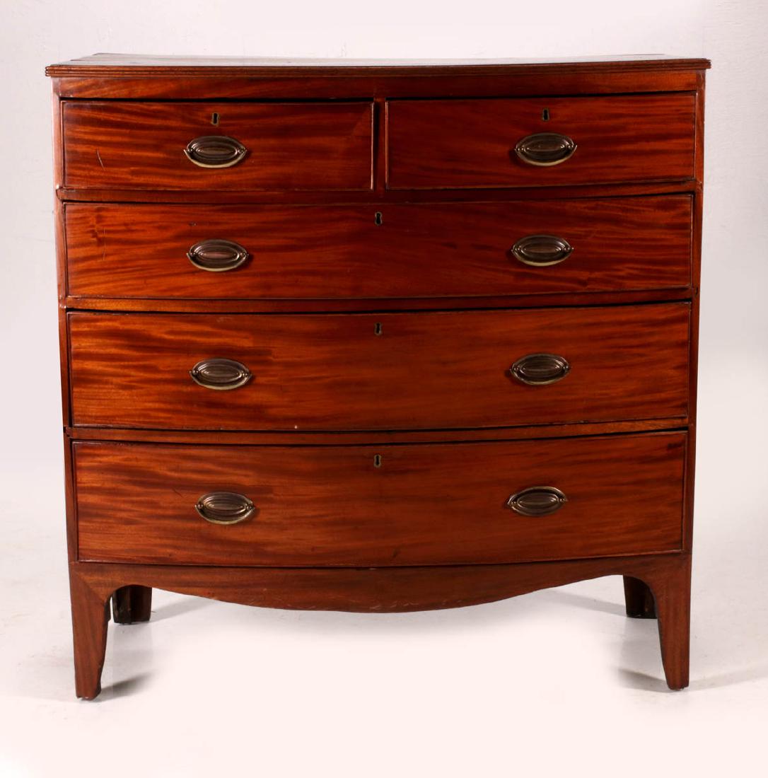 A CIRCA 1800 MAHOGANY HEPPLEWHITE BOW FRONT CHEST: The overhanging top with reeded edge, two short drawers over three long drawers. Measures 41 x 40 x 19.5. We happily provide seamless in-house packing and shipping services on nearly everything we sel
