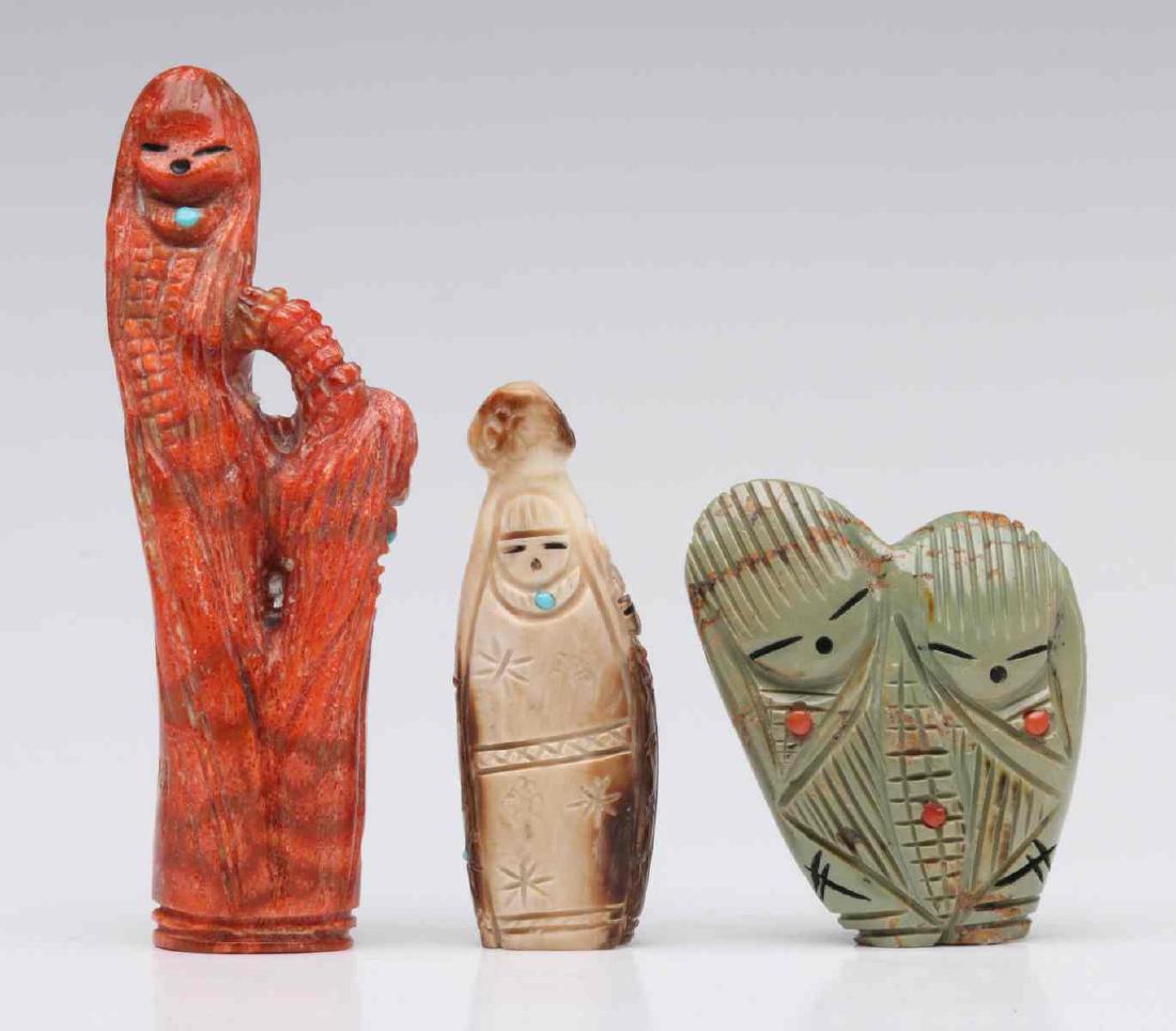 THREE ZUNI CORN MAIDEN FETISHES: The largest being a depiction of two corn maidens wearing turquoise necklaces with a single inlaid turquoise stone, carved from red/orange sponge coral, attributed to Faye Quandelacy. Plus a green Nev