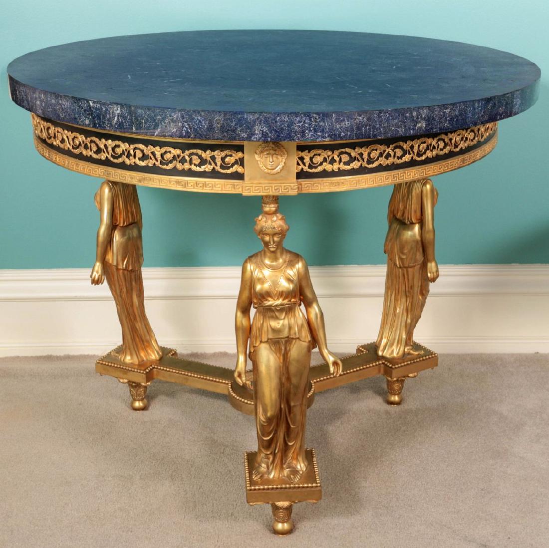 CONTEMPORARY GILDED BRONZE LAPIS TOP CENTER TABLE: French Empire style table with standing caryatid ladies in classical robes on tripartite base with central flame finial urn with goat heads, deep skirt with ebonized ground and Roman key pattern, genu