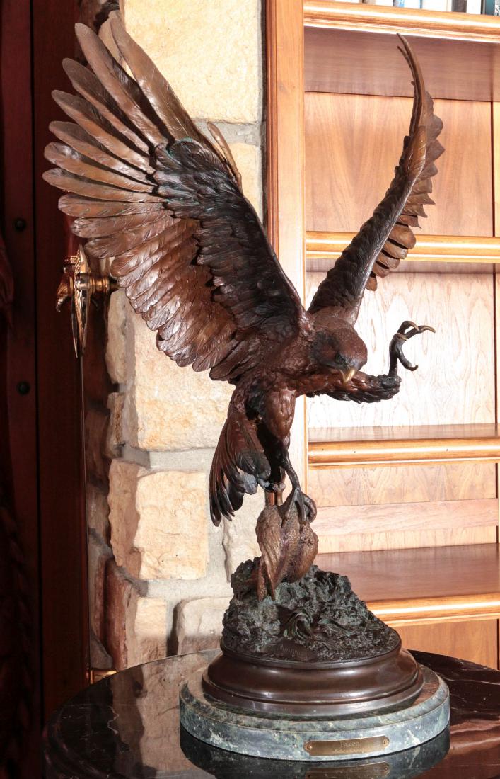 A LARGE HIGHLY DETAILED BRONZE FALCON SCULPTURE: A contemporary bronze sculpture accented by various black, brown and green patinas, AFTER the work by Jules Moigniez depicting a falcon rising in flight with a game bird in its talons. Measures 26 x 1