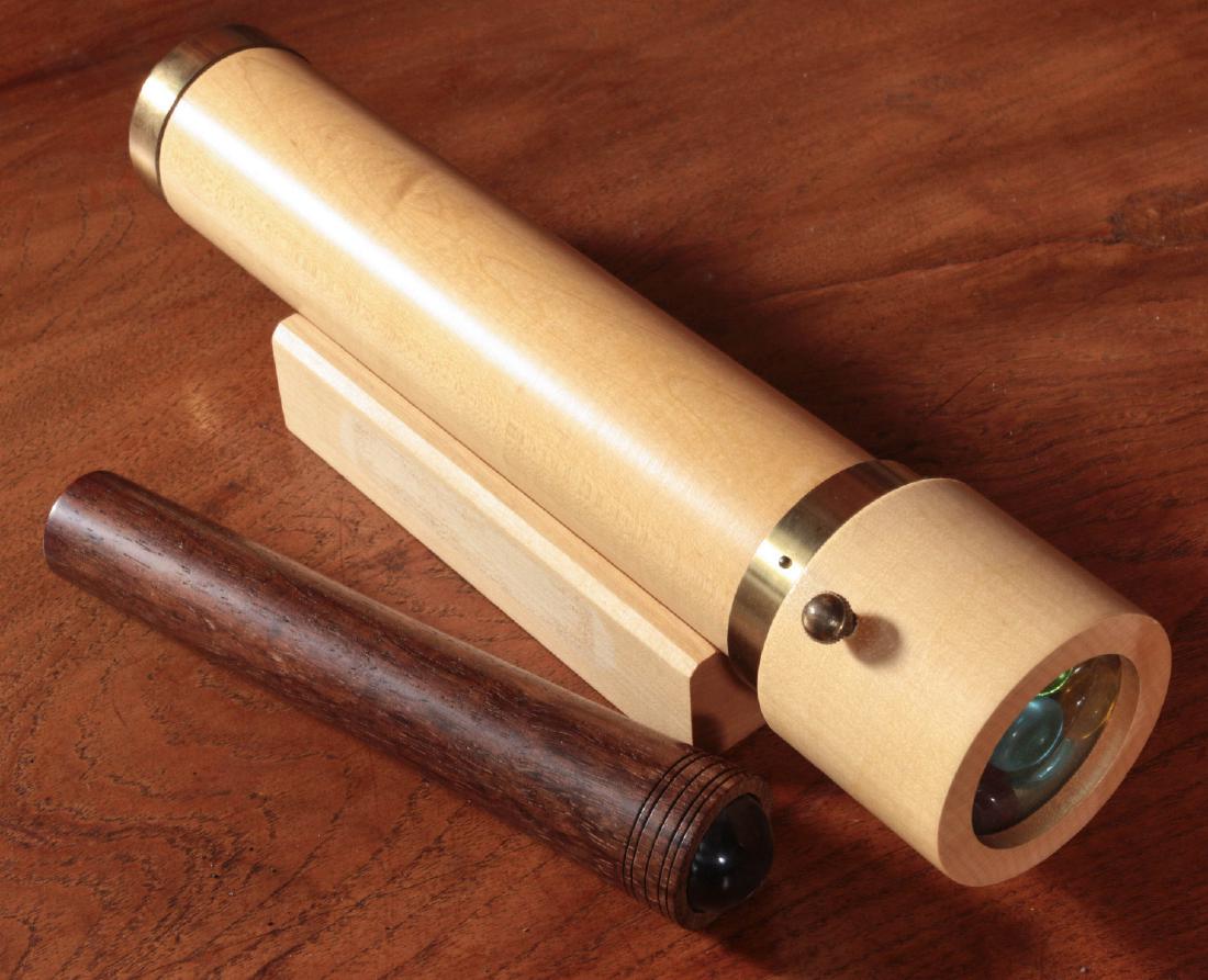 TWO CONTEMPORARY ARTISAN WOOD KALEIDOSCOPES: Two hand held models as shown. Measures 3 x 11.5 x 3 and 1 x 7.25 inches. Provenance: Spirit of Avalon Mansion and Gardens, Lake Quivira, Kansas For this auction only, any lot requiring shipping will 