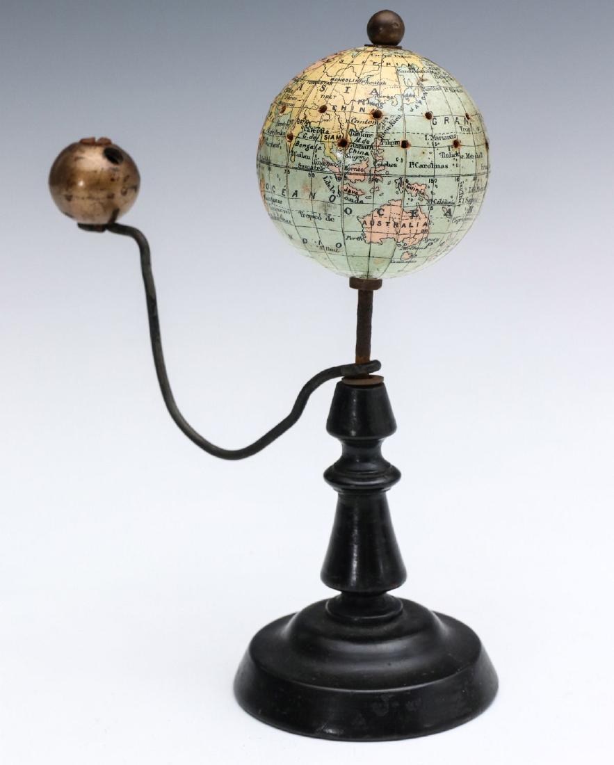 A LATE 19TH CENTURY FRENCH GLOBE, J. FOREST PARIS: The paper-covered paste board globe, on iron sg=hast, raised from wood base, wire arm with brass moon. Measures 7.25 x 6 inches. We happily provide seamless in-house packing and shipping services on n