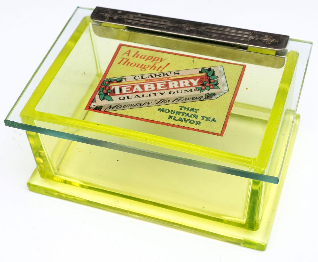 ART DECO ERA VASELINE GLASS TEABERRY GUM DISPLAY: The vaseline glass box with chromed hinge and original decal advertising Clark's Teaberry Gum, 'A Happy Thought!', THAT MOUNTAIN TEA FLAVOR. The glass fluoresces under UV light. Measures 2.75 x 6 x 4 
